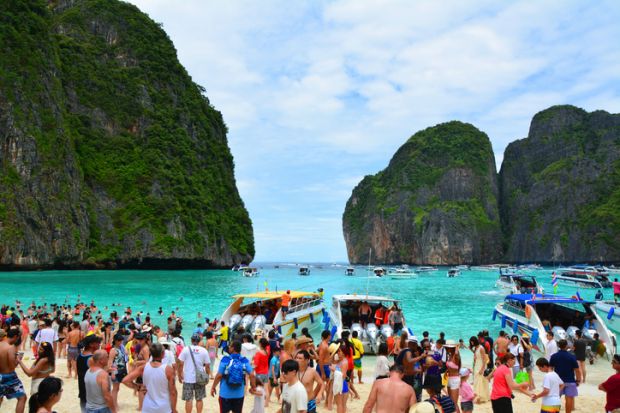 Famous crowded beautiful beach in Maya Bay. Maya Bay is closed due to damage to the coral reef by boats and intense tourism.