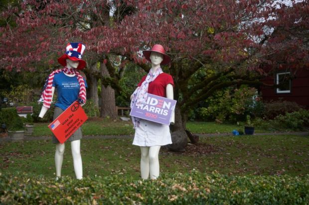 Mannequins dressed up and holding signs in support of the Democratic candidates are seen on the lawn outside a house in Lake Oswego, Oregon.