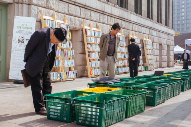 A street side book market outside Seoul City Hall near Seoul Plaza on a sunny afternoon in Seoul, South Korea.