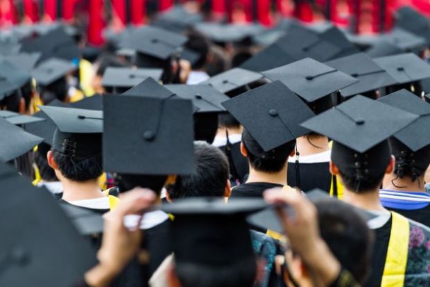 Students at a graduation ceremony, wearing mortarboards