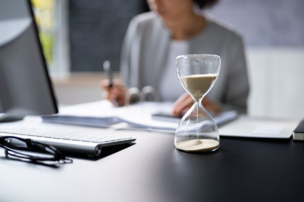 Hourglass on desk running out