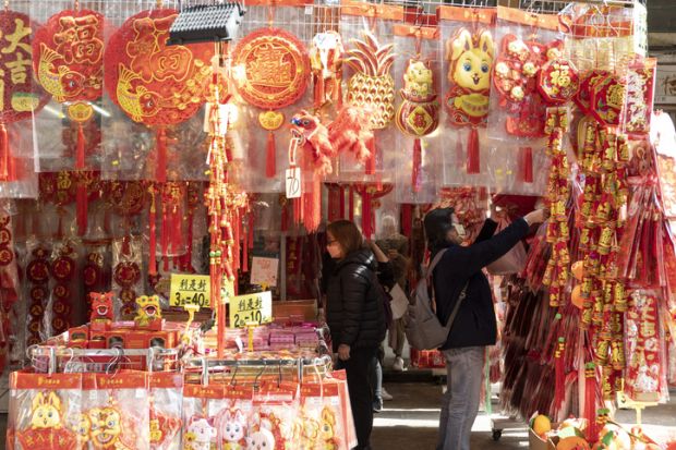 To celebrate the coming Chinese New Year outdoor shopping stalls place red goods representing luck for sale.