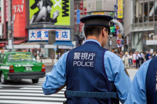 Japanese police presence at Shibuya Crossing, known as the scramble, the busiest pedestrian crossing in the world.