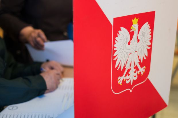 Person fills out ballot in Poland election