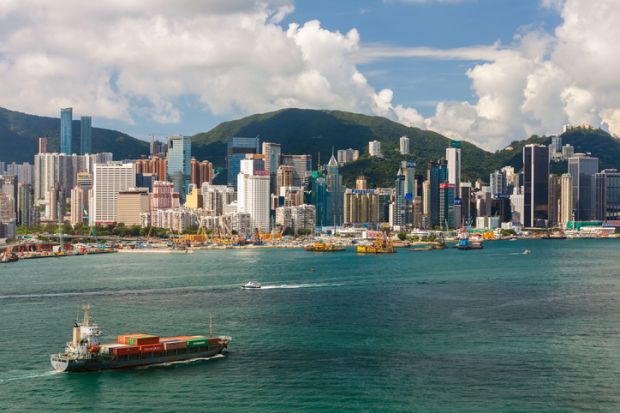 Container Ship and Hong Kong Victoria Harbour Skyline.