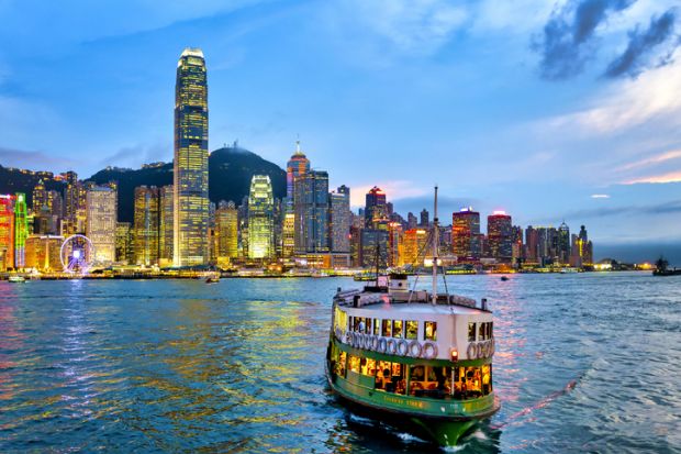 A star ferry in the Victoria Harbour at sunset, Hong Kong, China.