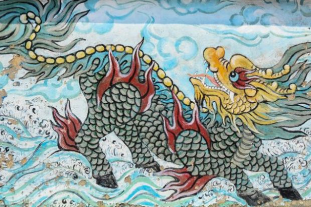 The colorful of old painting dragon on the wall of Chinese temple in Saigon, Vietnam.