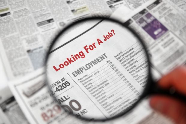 Magnifying glass searching job adverts illustrating graduate outcomes survey results