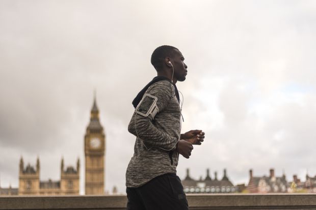 Young black man running outdoors illustrating article about a new app that shares academic research books and papers