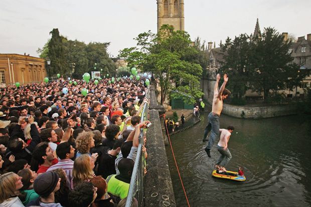 Oxford University students jump into the river from Magdalen Bridge