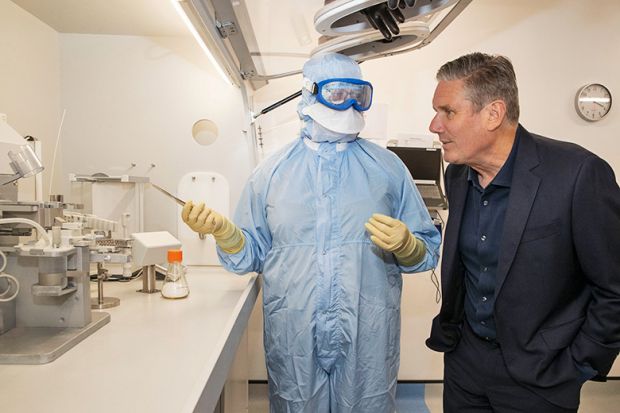 Keir Starmer speaks with a research scientist. To illustrate the Increased efforts made by universities to highlight the importance of quality-related (QR) research funding.