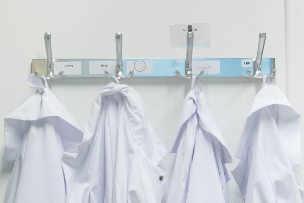 Lab coats on pegs