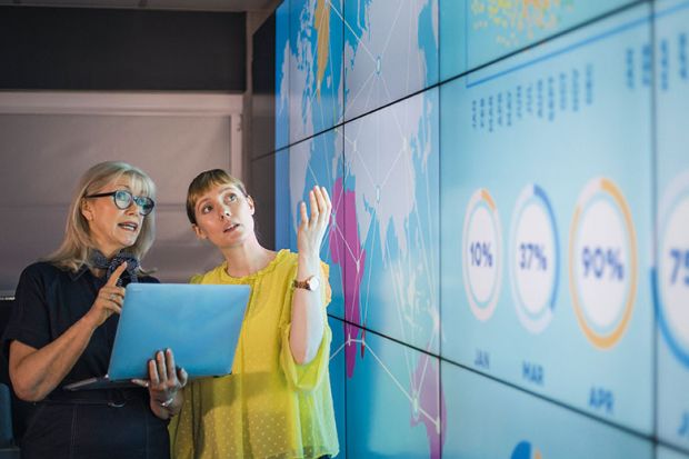 Women looking at information on screen