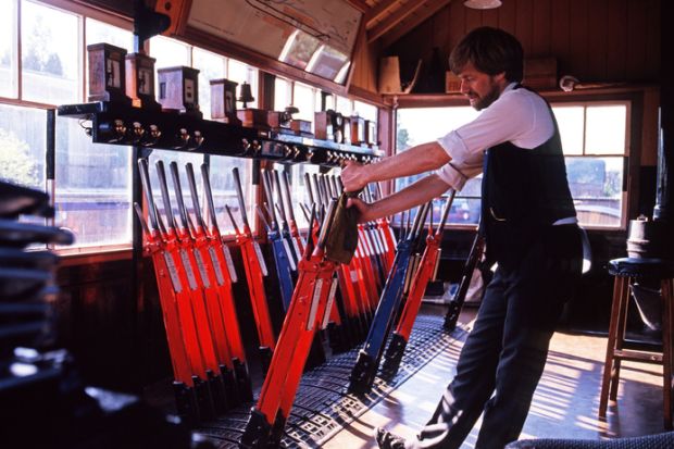 A signalman pulling levers