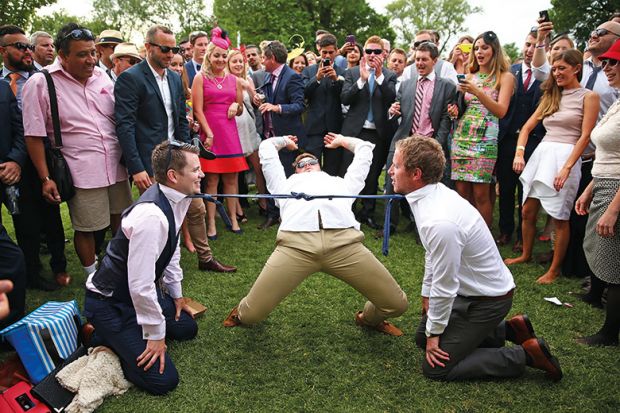 Man doing limbo under ties