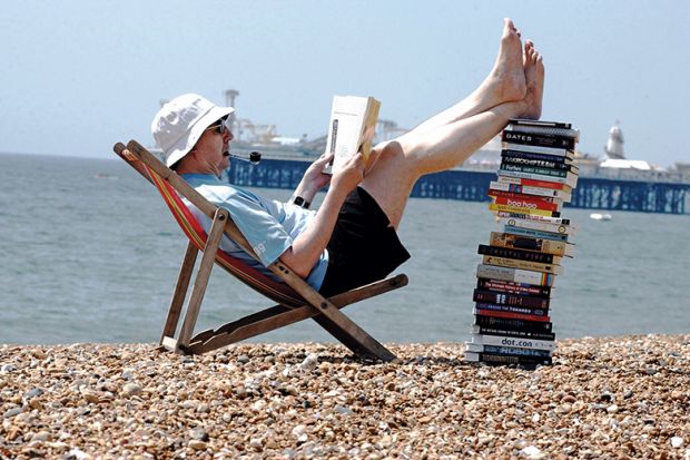 Man on beach reading