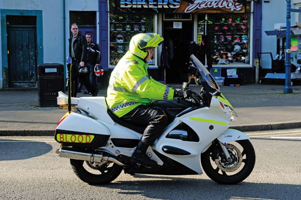 Man riding medical blood motorbike