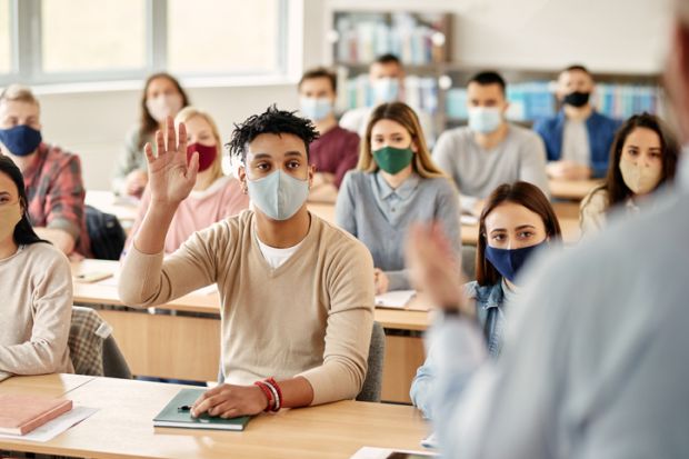 Masked students in a classroom illustrating an opinion article about returning to in-person teaching