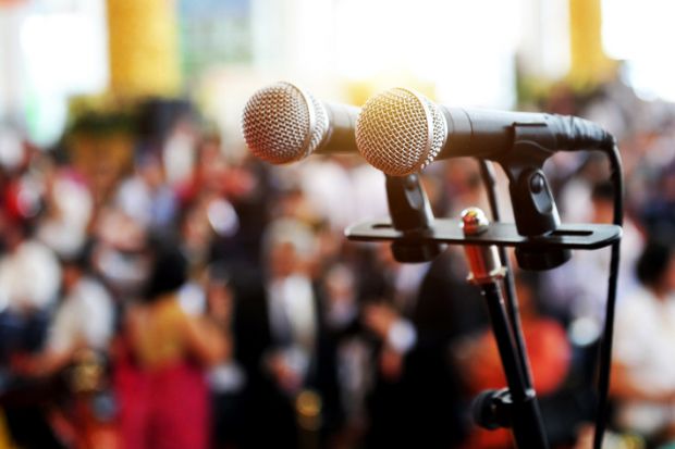 Microphones in from of an audience