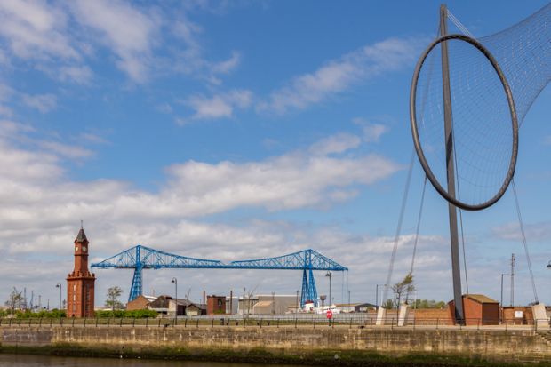 Middlesbrough, England, UK - May 14, 2016 View from the Middlehaven dock towards the transporter bridge, the old clocktower and Temenos