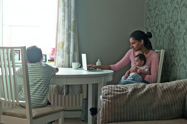 mother with child in front of a laptop computer