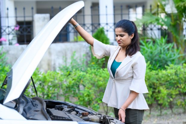 An Indian woman looks at the engine of her car, symbolising open science