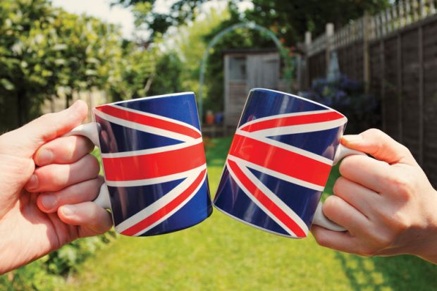 People holding Union Jack flag tea cups