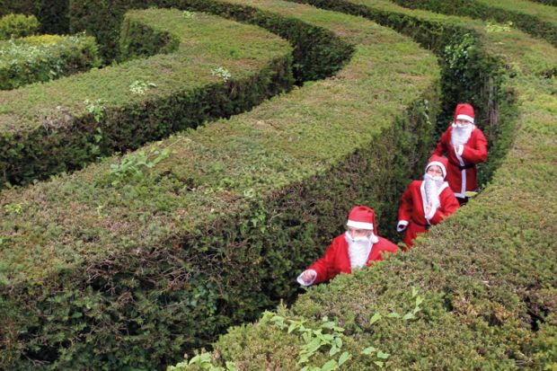 People in maze dressed as Santa Claus