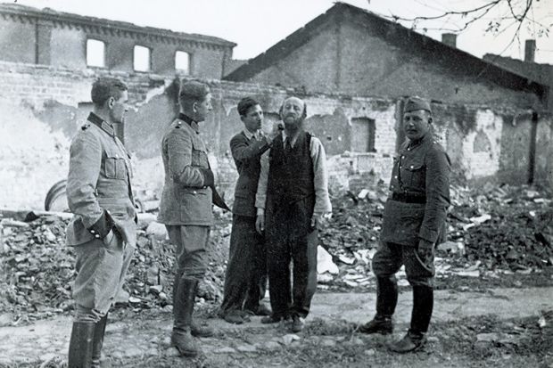 Polish civilian shaving Jewish man