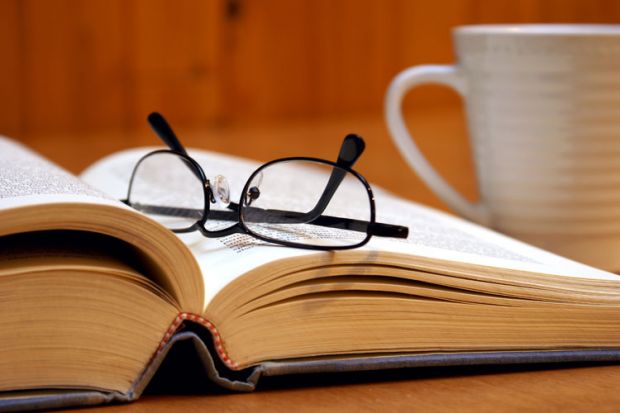 Reading glasses lying on open book