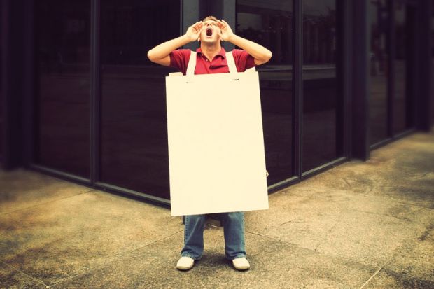 Screaming man wearing sandwich board in street