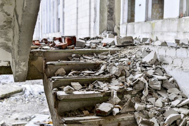 A shattered staircase covered in debris