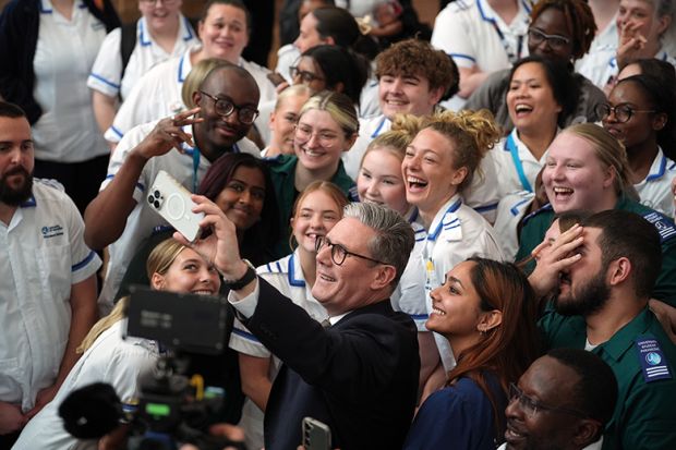 Keir Starmer taking a selfie with crowd of young people