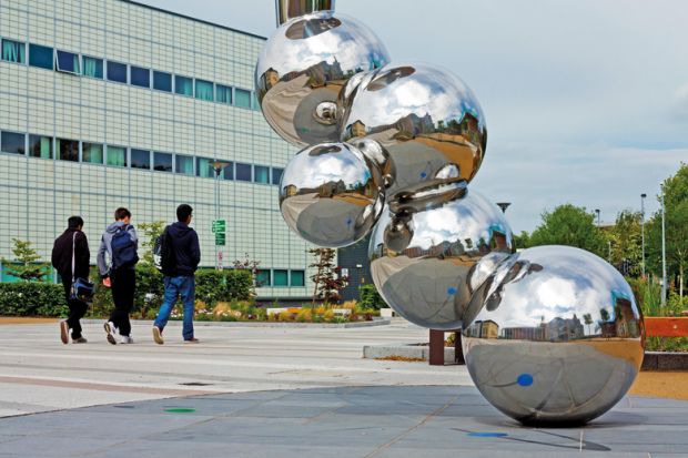 Students walking past sculpture, Loughborough University