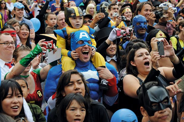 Father and son dressed as superheroes