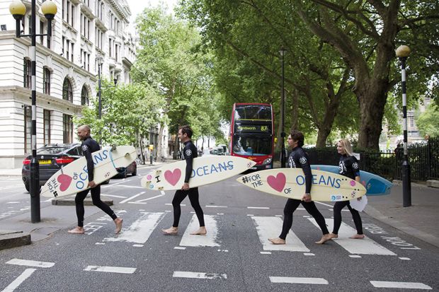 Surfers cross the road