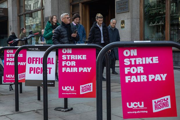 University and College Union (UCU) posters demanding fair pay are pictured at an official picket