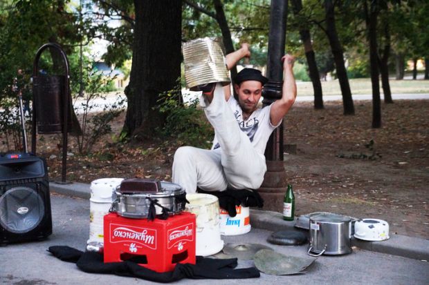 Varna, Bulgaria - September, 06, 2020 street drummer playing in the park with improvised means