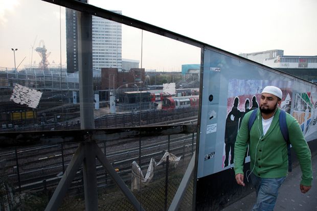 Man walks past wall