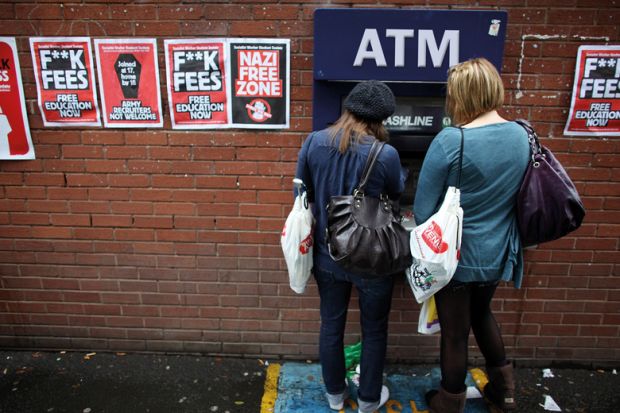 Students arriving for Manchester University's freshers week queue up at a cash machine in Manchester, England. 