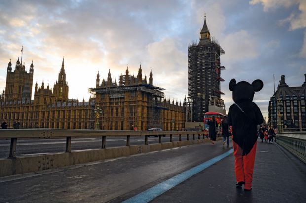 A man in a Mickey Mouse costume walks past the Houses of Parliament to illustrate ‘Mickey Mouse degrees’ rhetoric expected to survive Tory rebuild