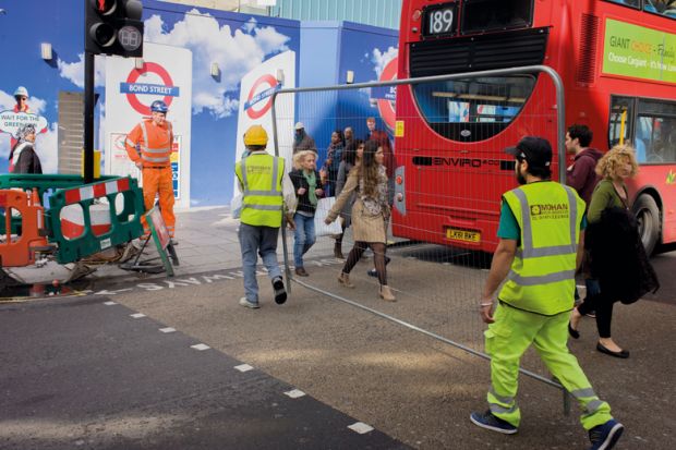 Workman carry a construction fence across Oxford Street in central London to illustrate Shift to relationship bans ‘signals new approach in universities’