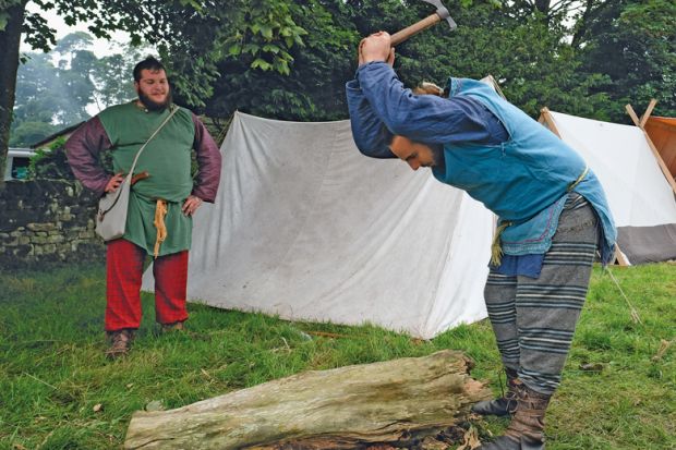 Members of the Barbarian camp chop firewood as the lives of Roman Legionnaires are re-enacted in the UK to illustrate More than 100 research posts at risk at Sheffield nuclear centre