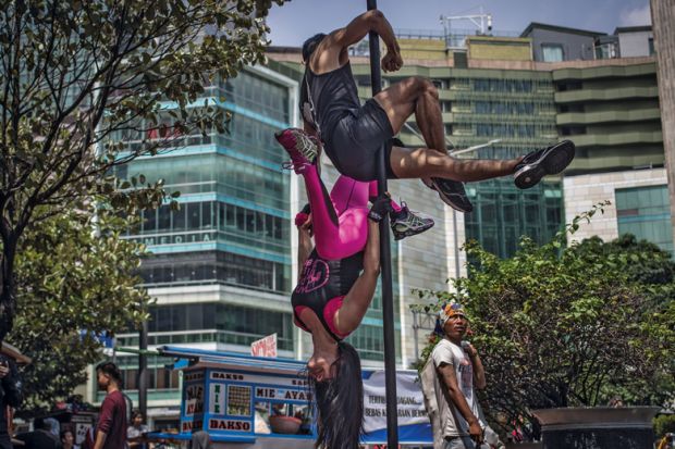 Indonesian dancers practices the pole dance in Jakarta to illustrate Monash seeks to improve postgraduate progression in Indonesia