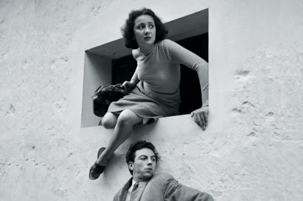 Woman escaping through a window, France, 1935