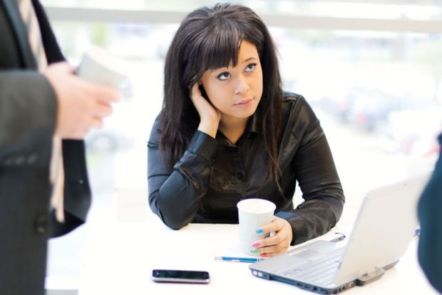 Young woman seated in front of laptop computer