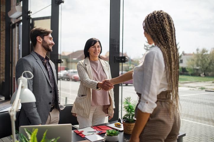 young woman shaking hands at an interview