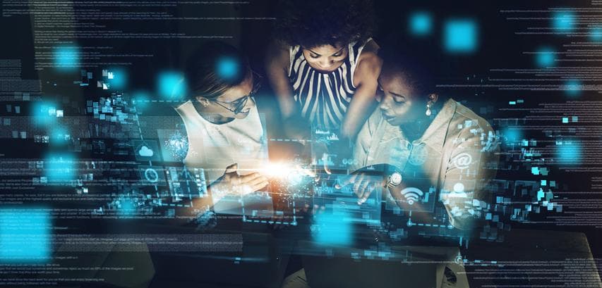 women gathered around an invention